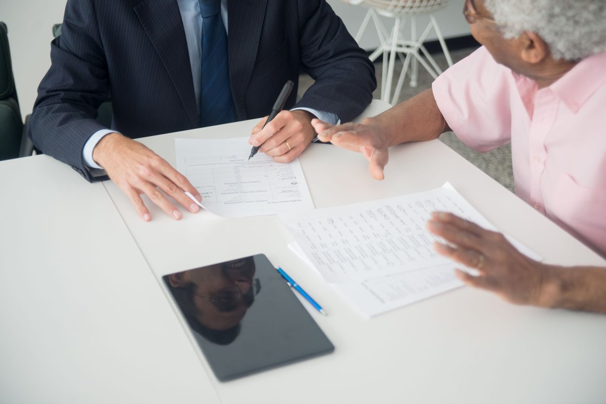 Agent reviewing plan documents with a client