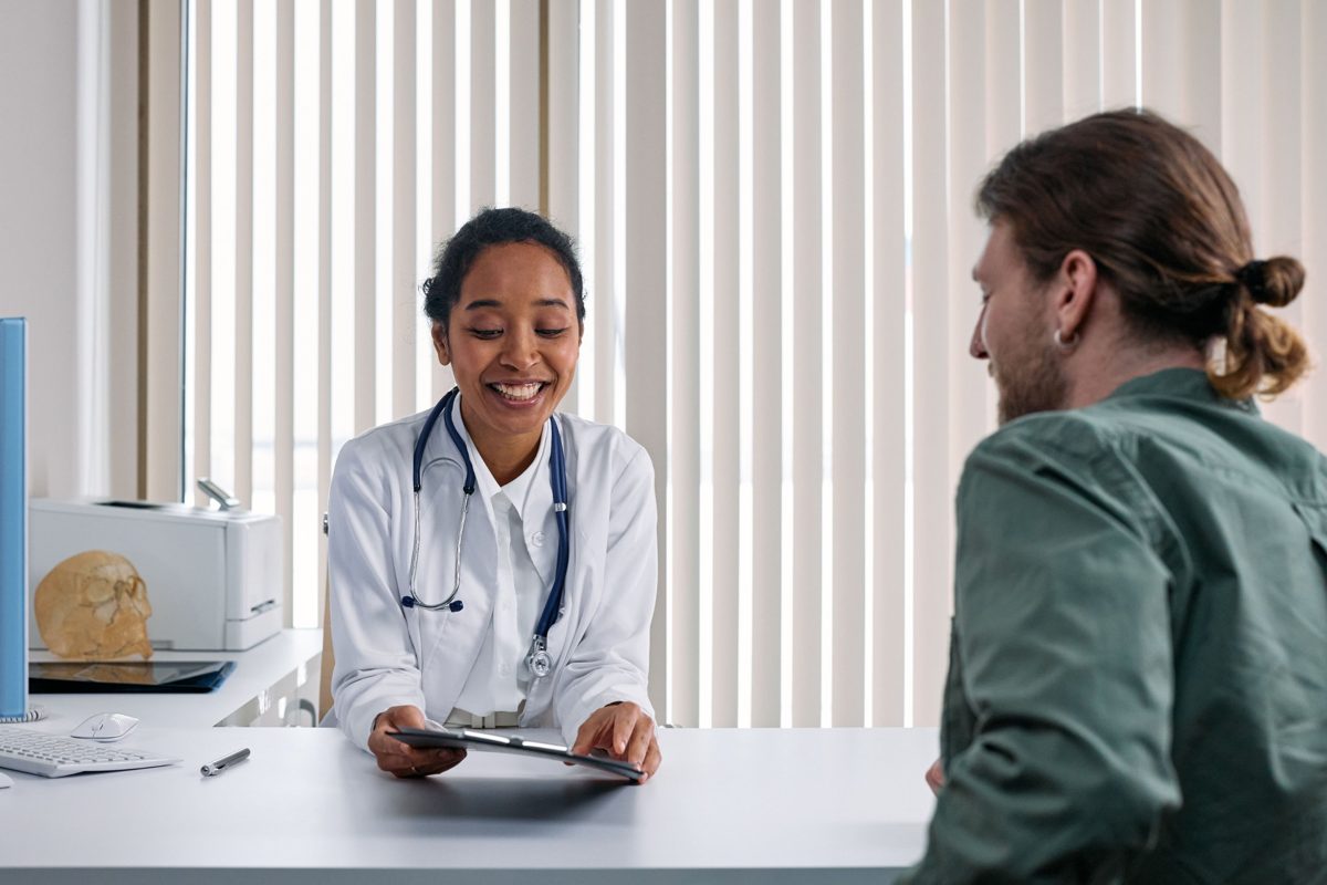 Doctor smiling while reviewing a chart with a patient